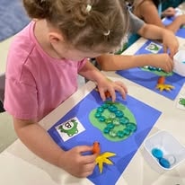 Child doing a colorful craft activity